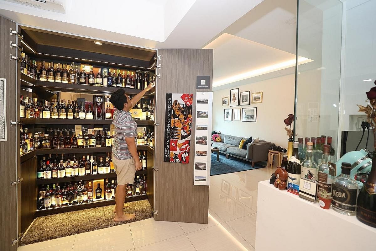 Ms Candy Low (with her daughter Claris Fong) and her husband Andy Fong, who is not in the photo, have a bar in their executive condominium apartment where they host friends and relatives for drinks. Mr Colin Ong turned one floor of his bungalow into 