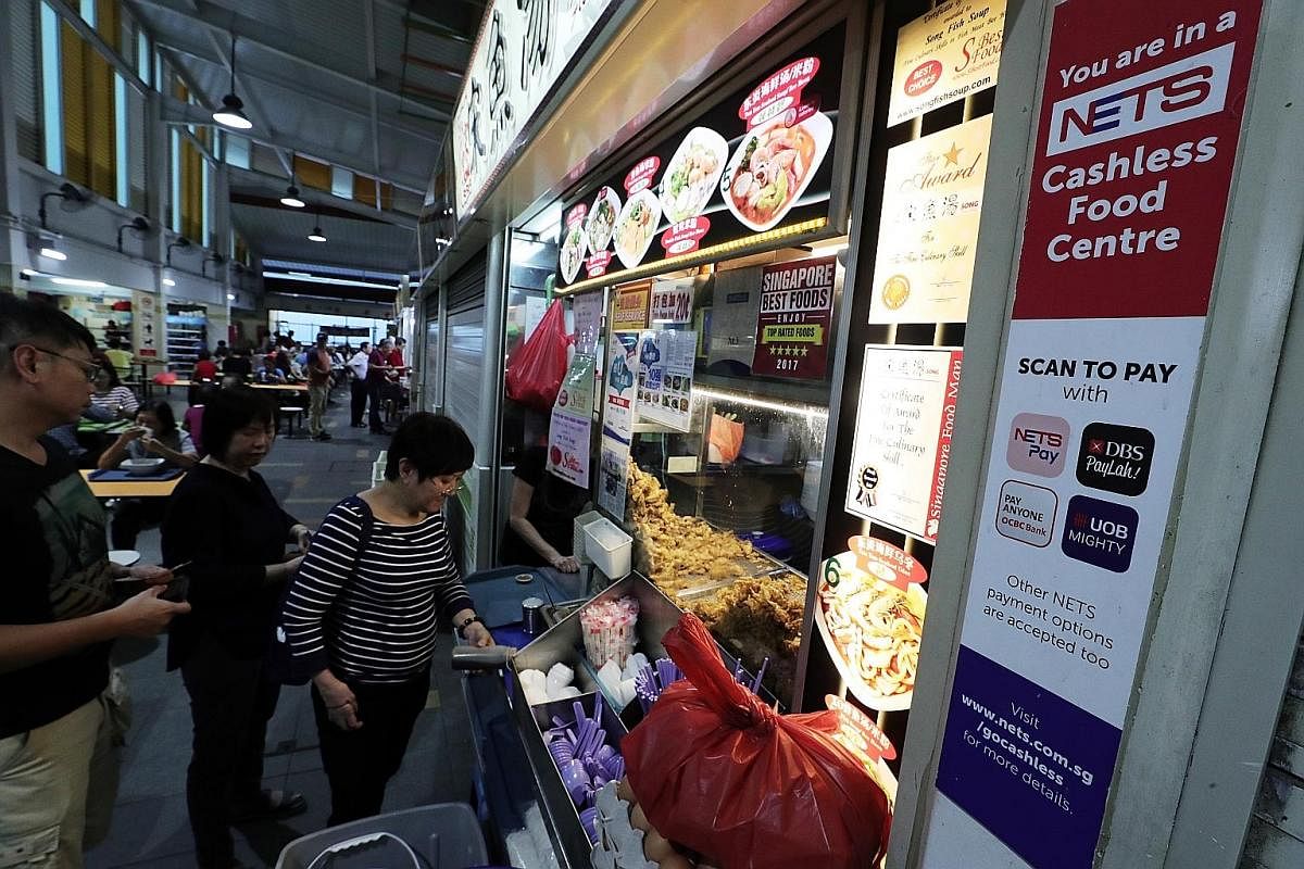 Under its cashless payment system, Nets will give hawkers hardware to accept e-payments from 20 sources, including e-wallets.
