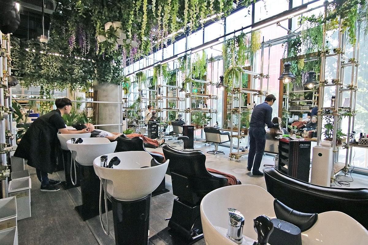 Above: The garden-themed Walking on Sunshine hair salon in Orchard Central houses a cafe that serves brunch and Korean-inspired food. Left: Chez Vous: HideAway in Ngee Ann City boasts themed areas designed for photos, including a millennial pink room