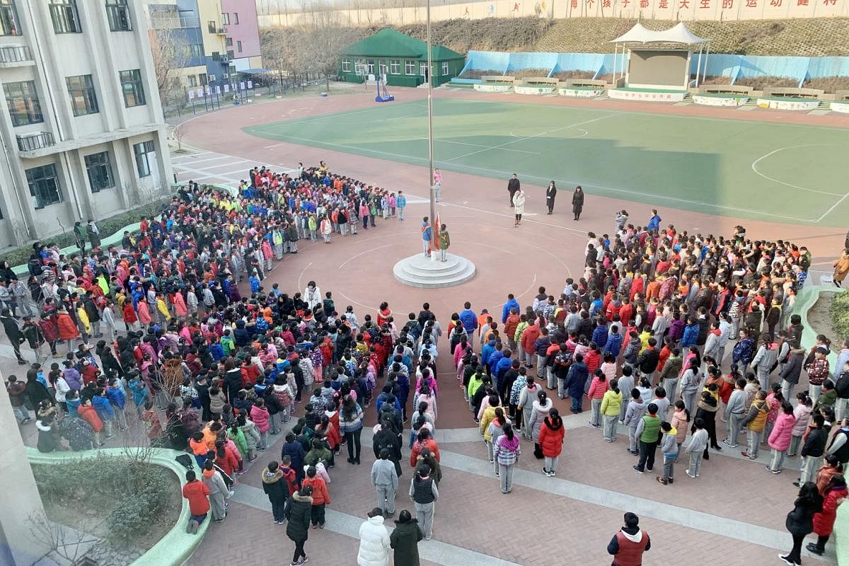 Liangxiang No. 4 Elementary School pupils gathering for morning assembly. The school is one of about 20 in China that uses the Edubrain AI system. The AI system uses facial recognition technology to check if pupils look happy, sad or have a neutral e