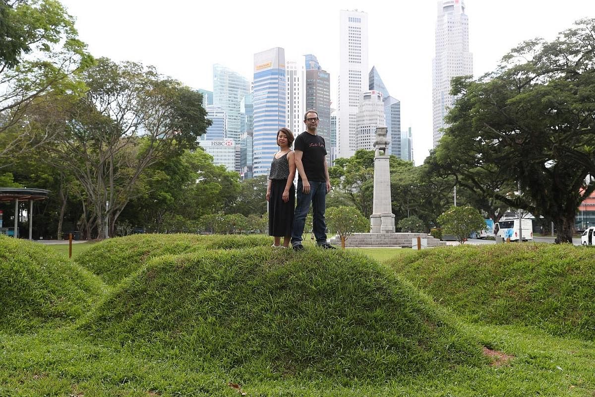 Sebastian Chun with his installation Sticks on the Asian Civilisations Museum lawn. Kaylene Tan and Ben Slater on a mound which is part of their audio installation, Under The Five Trees, at Esplanade Park.
