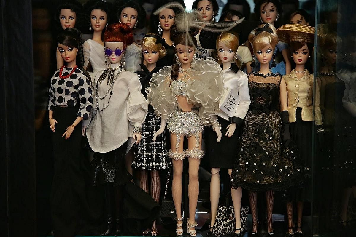 The most expensive Barbie in Mr Yang's collection is a Silkstone doll decked in Swarovski crystals. He paid $3,600 for it at a charity auction in 2000. Mr Yang takes a selfie with a Ken doll customised to look like him. Four Barbie mermaid dolls on t