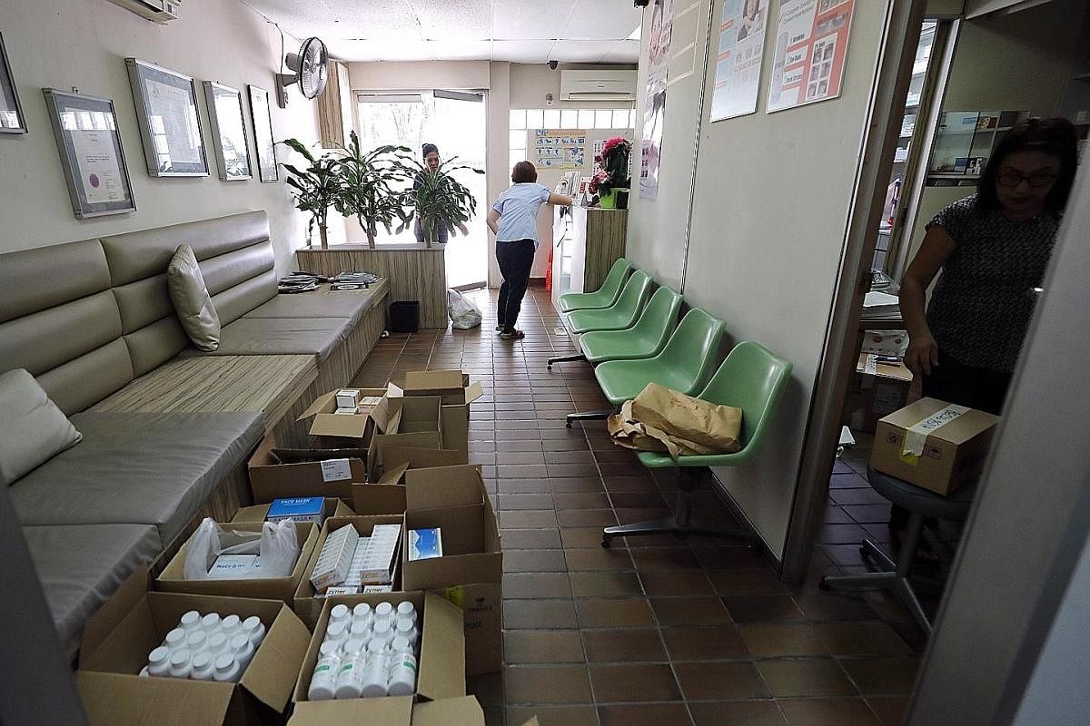 Staff packing items into boxes yesterday. The clinic is moving to Royal Square Medical Suites in Novena, where it will open with a new name: Lily Neo Clinic. The clinic was one of the last few outlets still operating in its block ahead of a 2021 dead