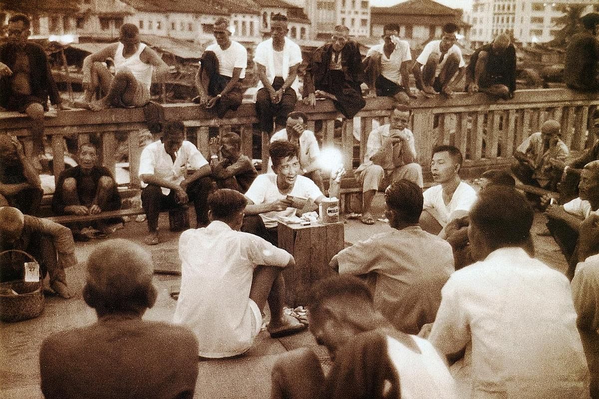 Left: Before the pubs and restaurants moved in, coolies along the banks of the Singapore River in 1960 looked to storytellers for entertainment. Scenes from The Bicentennial Experience at Fort Canning Centre will include a depiction of Raffles and hi