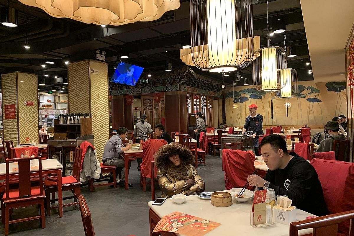 Customers at the Jindingxuan restaurant in eastern Beijing (above) past 2am on a weekday. The 24-hour dimsum restaurant (below) does a brisk business because Beijing has few restaurants that open till the wee hours, and fewer still that never close.
