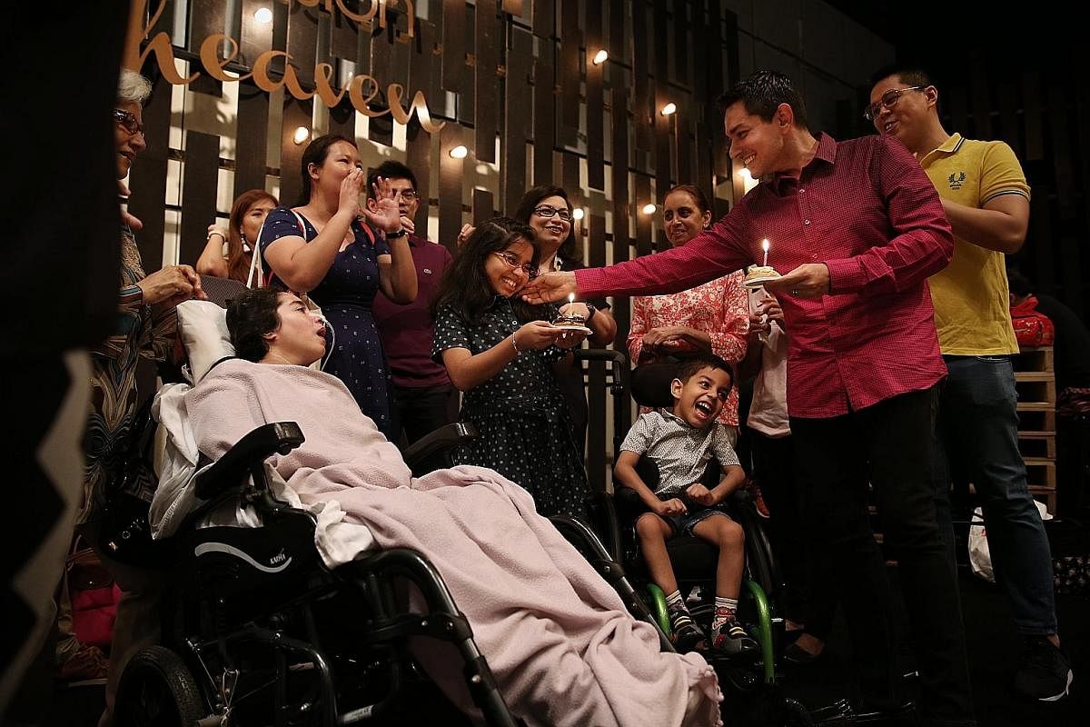 Mr Vishindas during a church worship service at Suntec City convention centre, as his mother-in-law Rani Sham Baharani watches over Madam Pooja. Mr Vishindas and Madam Kaur supporting Ryan, now six, on the monkey bars at the playground. Ryan suffered