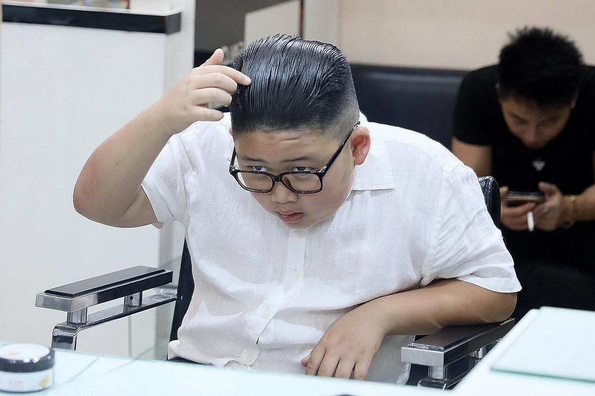 Nine-year-old To Gia Huy checking out his Kim Jong Un-style haircut while 66-year-old Le Phuc Hai admires his Donald Trump-inspired dyed hairdo at a salon in the Vietnamese capital, Hanoi, ahead of the US-North Korea summit this week.