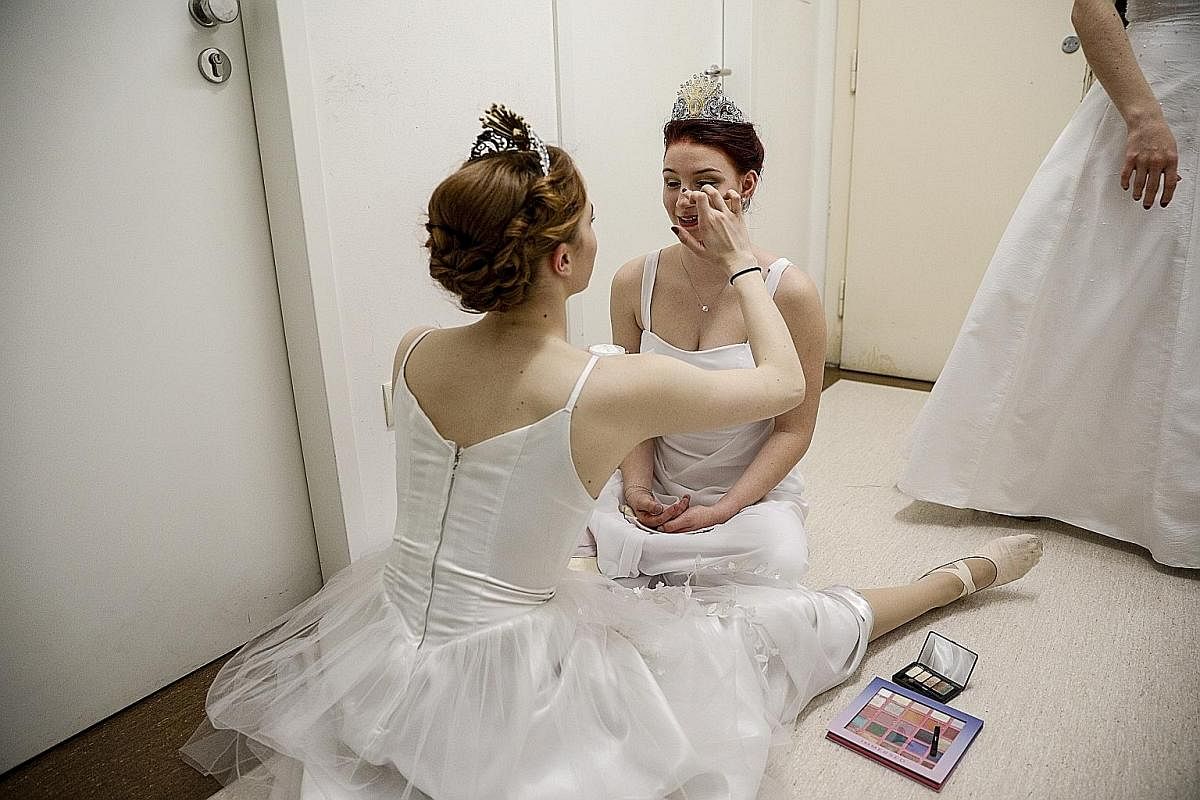 BEHIND THE SCENES: Debutantes putting on final make-up touches before the opening ceremony of the Vienna Opera Ball last Thursday.