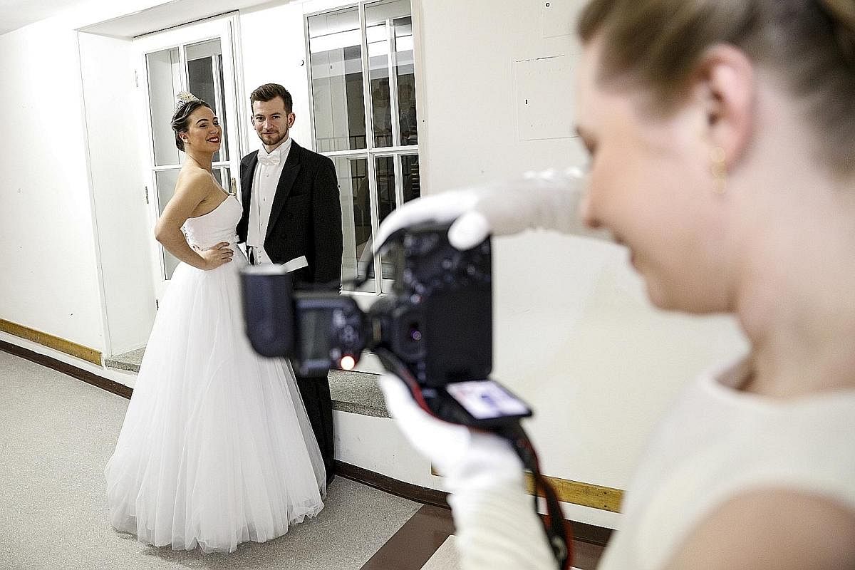 BEHIND THE SCENES: Debutantes having their photos taken backstage before the opening ceremony of the Vienna Opera Ball last Thursday.