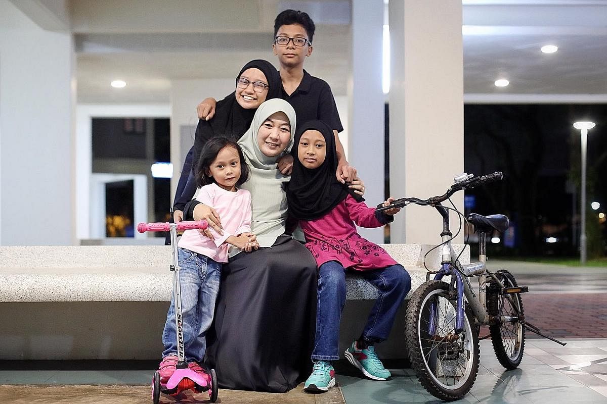 Ms Suhaila Subtu with her children (clockwise from left) Ayla Zulaykha, four; Sara Syaakirah, 14; Umar Abdul Aziz, 12; and Huda Nusaybah, nine. Ms Suhaila, who has taken parenting classes, says there is a lot to keep up with for each child and his or her 