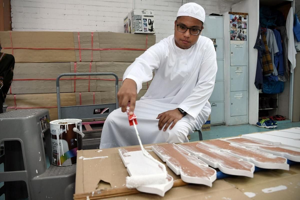 Mr Razaly paints temporary tomb markers known as kayu nisan, on which details of the deceased are written before the actual tombstone is erected. Grave markers are simple as lavish displays are discouraged in Islam.