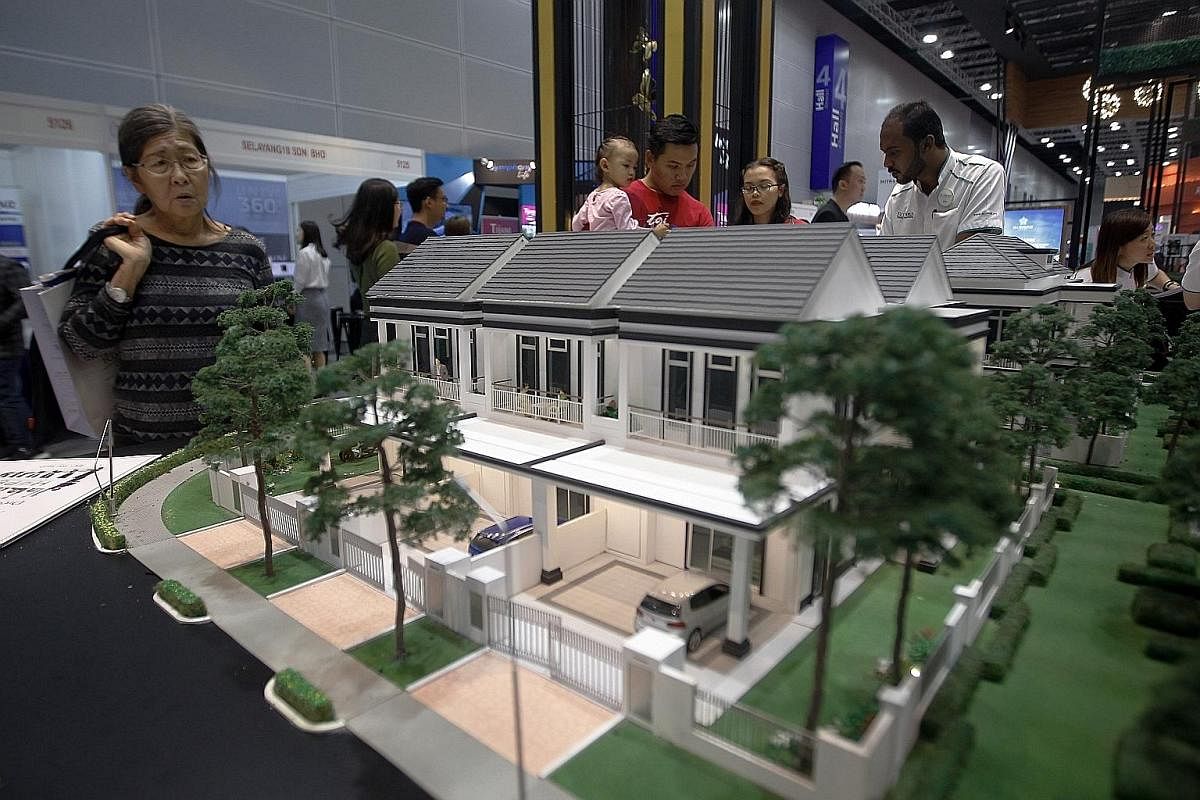 Home buyers checking out a housing expo early this month in Kuala Lumpur, where 180 developers offered 22,000 housing units priced at RM300,000 or less. Developers were asked to offer at least a 10 per cent discount, and the government will exempt st