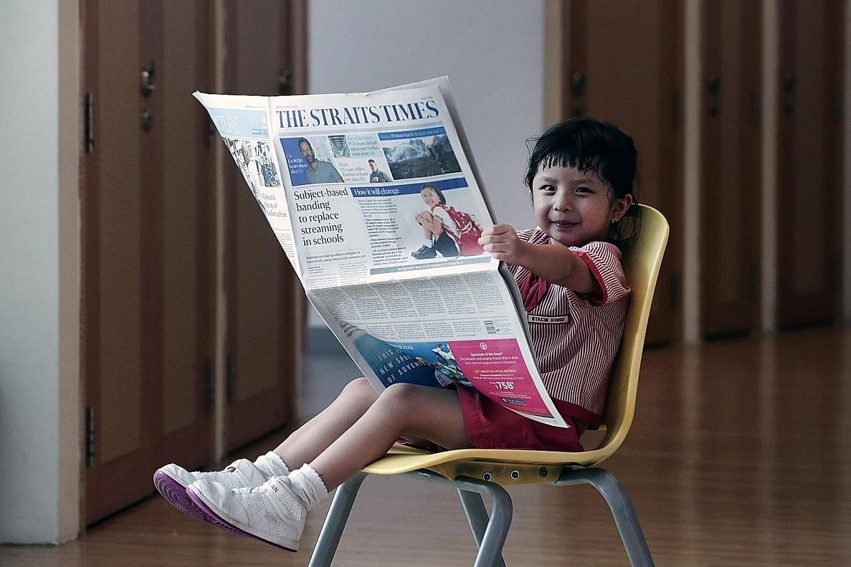 Stacie Khng (left), five, enjoys reading short articles in The Straits Times. Sashayna Vincent (left), six, could read WhatsApp messages when she was only 18 months old. Athena Wei (left), five, with two books for advanced readers of her age. She rea