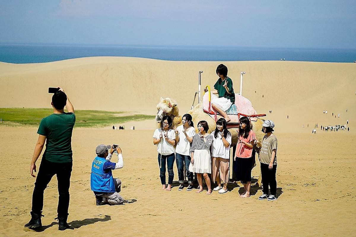 (Left) In summer, fun-seeking travellers can go camel riding, sandboarding and paragliding at Tottori's sand dunes, the largest in Japan. Winter time sees Tottori covered in snow, such as on ski slopes (above). (Above) Perched on a precipice, the Nag