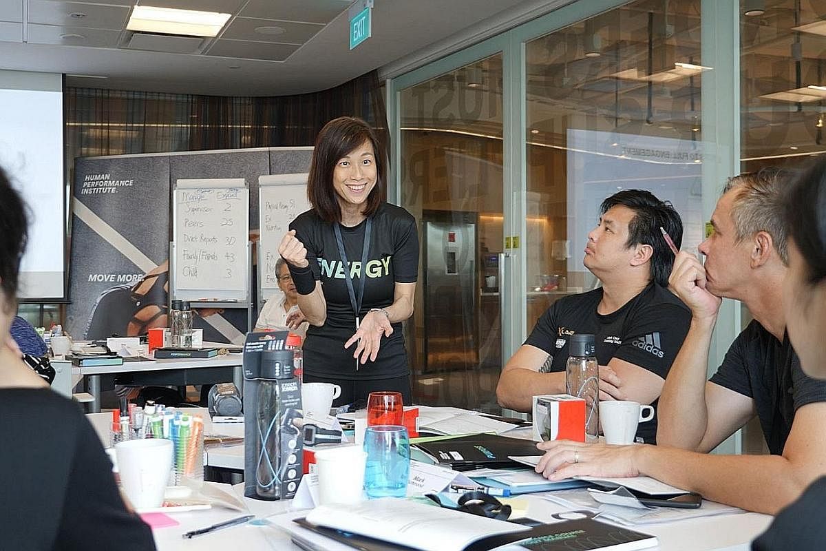 Johnson & Johnson Human Performance Institute trainer Chan Wai Yee guiding participants at the course to identify personal goals.