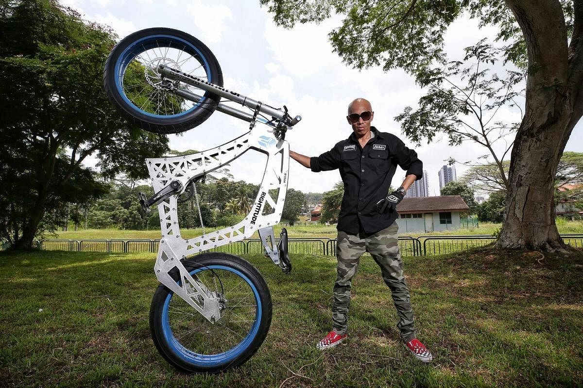 Lewis Foo (above) on his unusually long bicycle. Rosman Lamri's motorbike-looking dream bike (right) is just one of his eight customised bicycles.