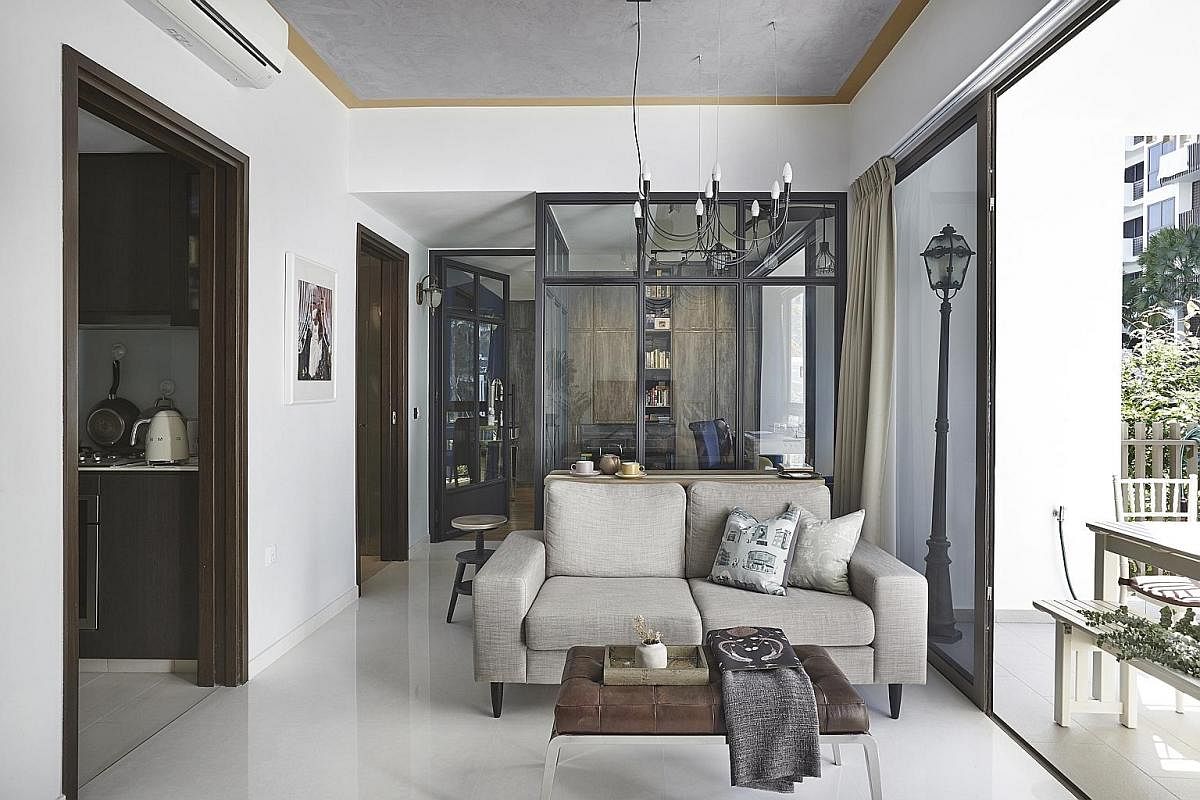 To create visual spaciousness and openness in the apartment of civil servant Cheong Mei Xi, tall glass panels in black frames instead of concrete walls separate the master bedroom from the living room (above). 