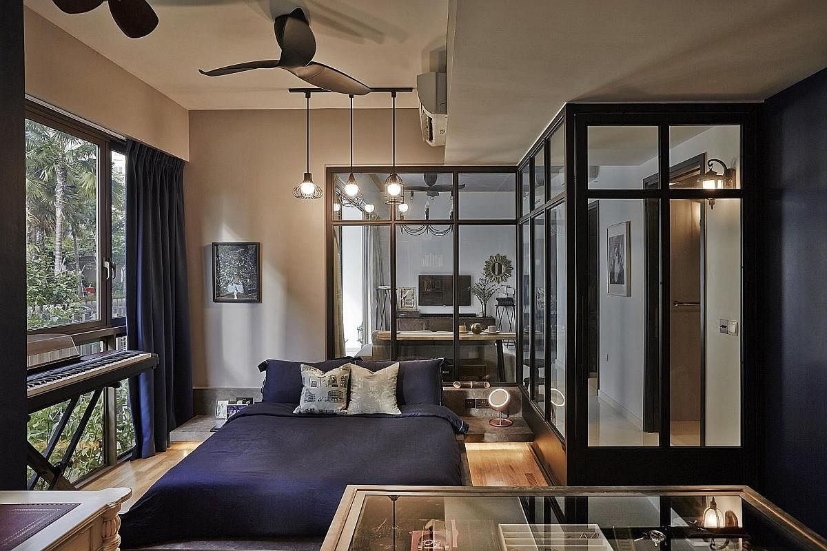 To create visual spaciousness and openness in the apartment of civil servant Cheong Mei Xi, tall glass panels in black frames instead of concrete walls separate the master bedroom (left) from the living room (above). Use floor-to-ceiling mirrors (lef