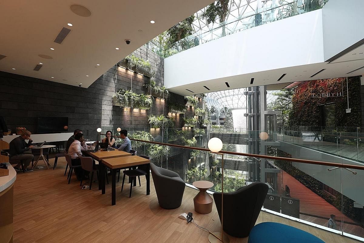 The lounge at Yotelair overlooks the Rain Vortex at Jewel Changi Airport.