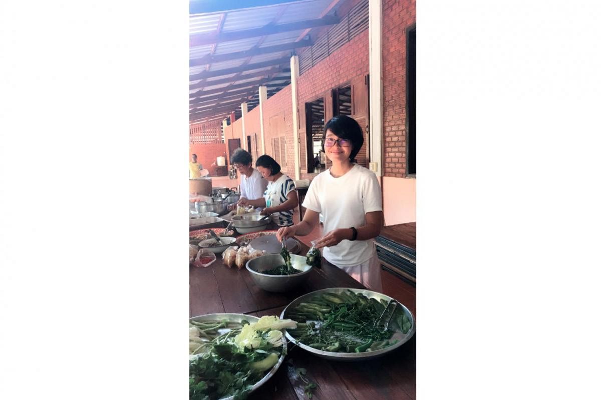 Entrepreneur Koh Kai Xin helping to pack leftover food for distribution in a monastery in Ubon Ratchathani, Thailand, this year. She enjoys going on Buddhist retreats, often for a month at a time. 