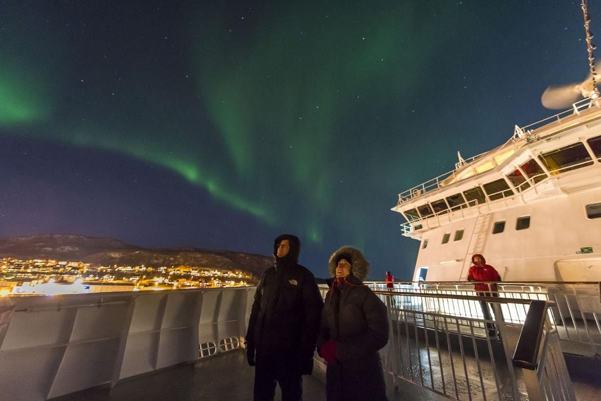 Northern Lights on a Hurtigruten cruise (above) and Old Man Neptune pouring ice cubes down a passenger’s back to mark his passing of the Arctic Circle.