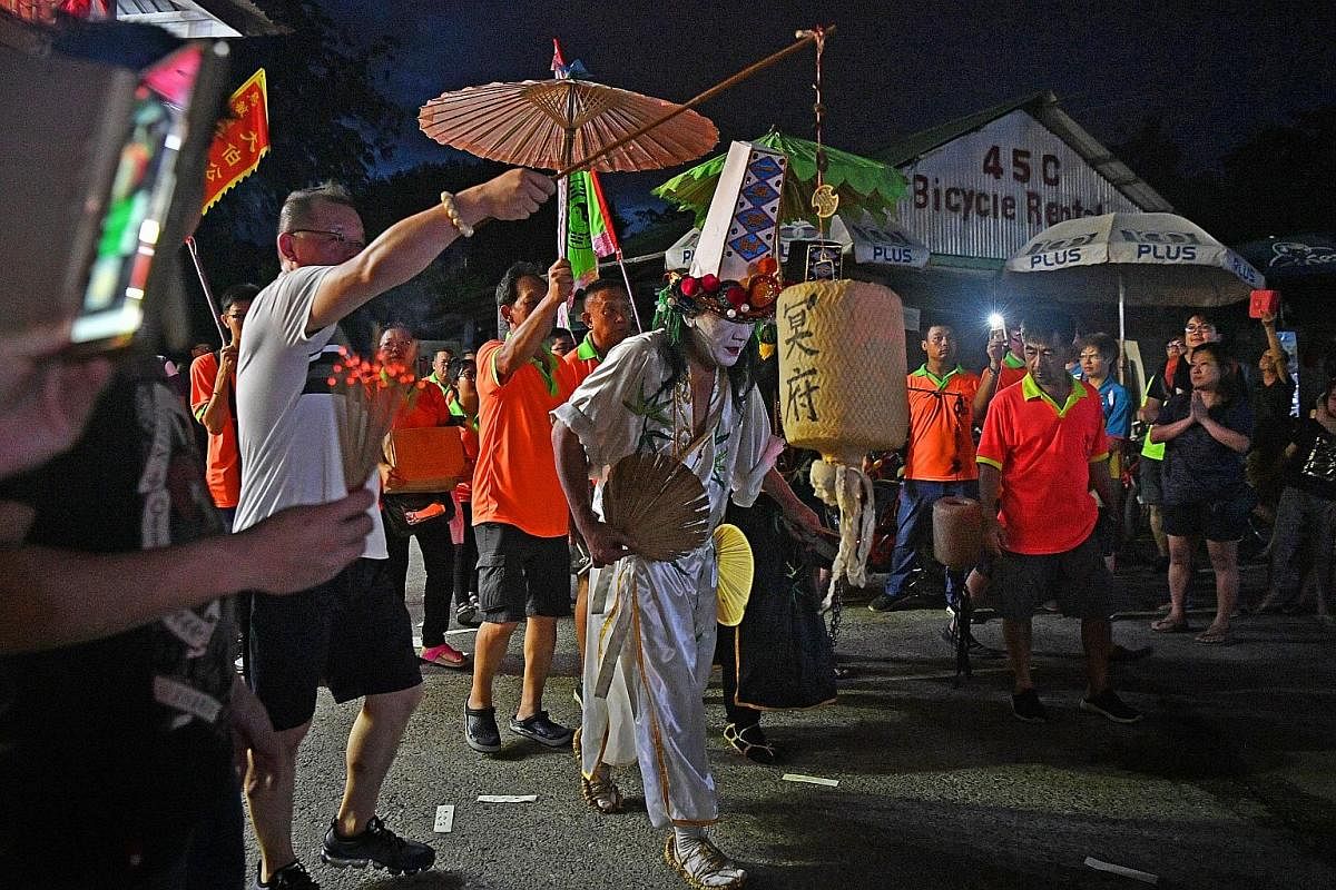 Above: A dragon dance troupe - one of five taking part in the celebrations - arriving at Ubin on May 12. Right: A pagoda-shaped incense furnace was rebuilt based on the original one. The new temple is also identical in design to the one it replaced. 