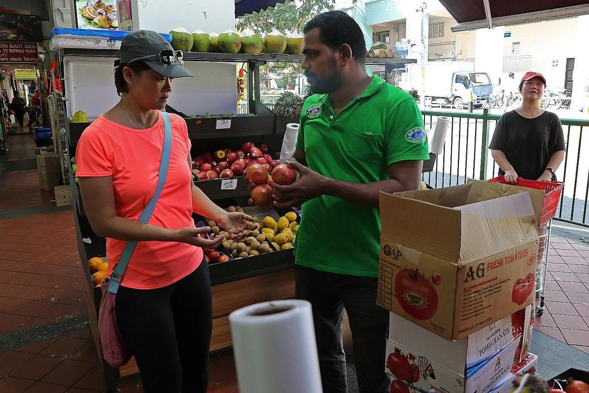 Boxes of fruits and vegetables that are sorted and ready for volunteer drivers to pick up and deliver to local charities. Within an hour, volunteers can collect more than 1,000kg of food at the wholesale market. Volunteer Nicolas Theodoru pushing a t