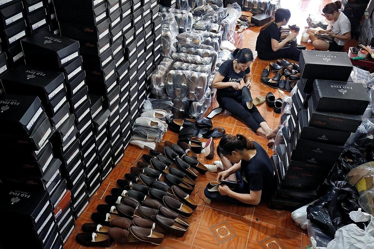 Left: Women working at a Maxport garment factory in Thai Binh, a coastal province in the north, on June 13. Workers at a shoe factory in Dong Van Town, in northern Vietnam. Proximity to China, cheap labour, a raft of trade pacts and ongoing efforts t