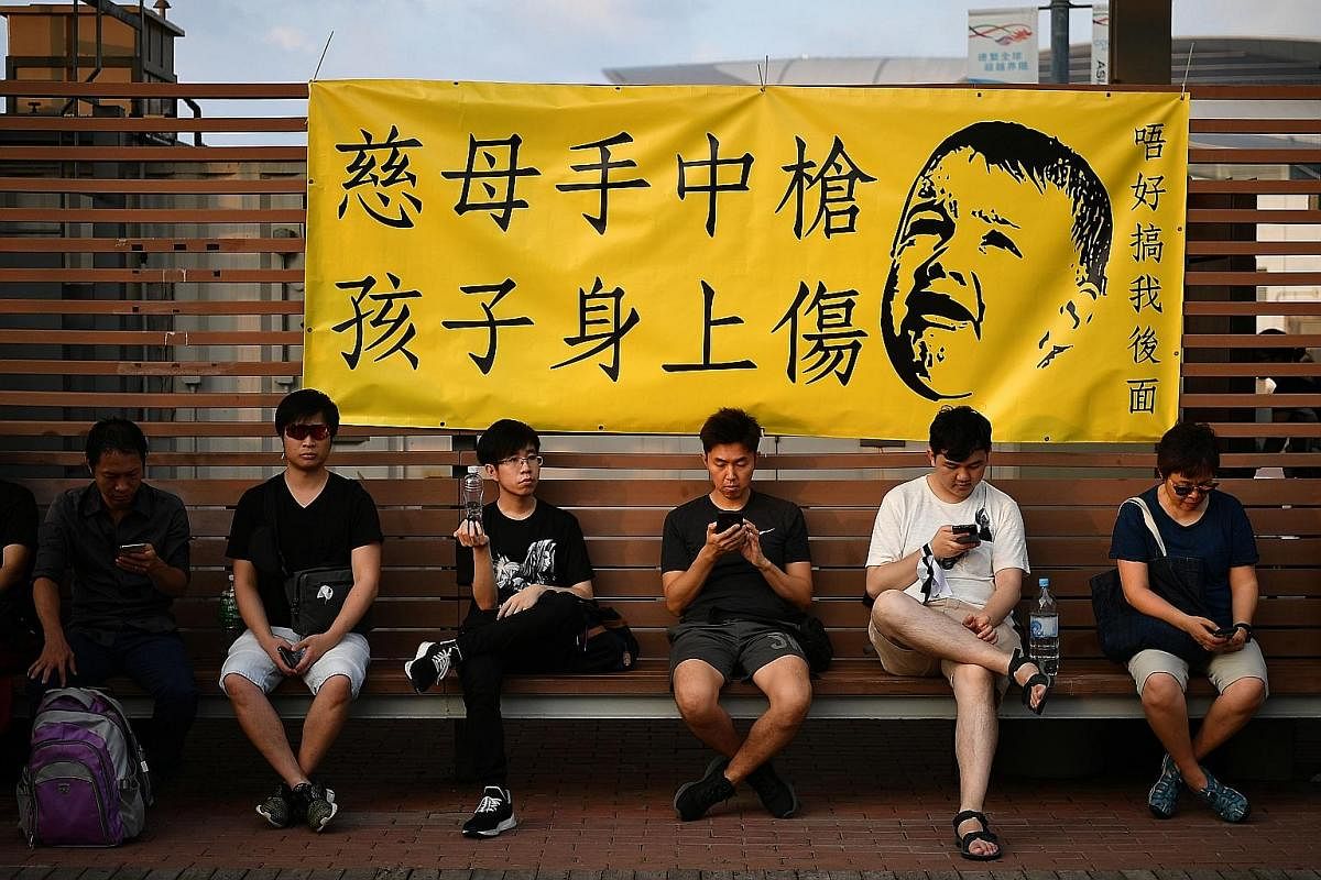 Protesters in Tamar Park on Sunday. Young protesters have learnt from the previous mass protest: Many communicate now through secure messaging apps, use prepaid SIM cards and wear masks to obscure their faces.