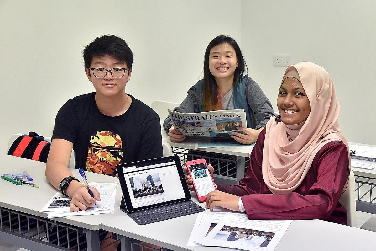 The Straits Times is one of the resources students at enrichment centre Write Edge (from far left), Daryl Wong, Sarah Teo and Fatimah Ramadhan, use to improve their vocabulary and communication skills.