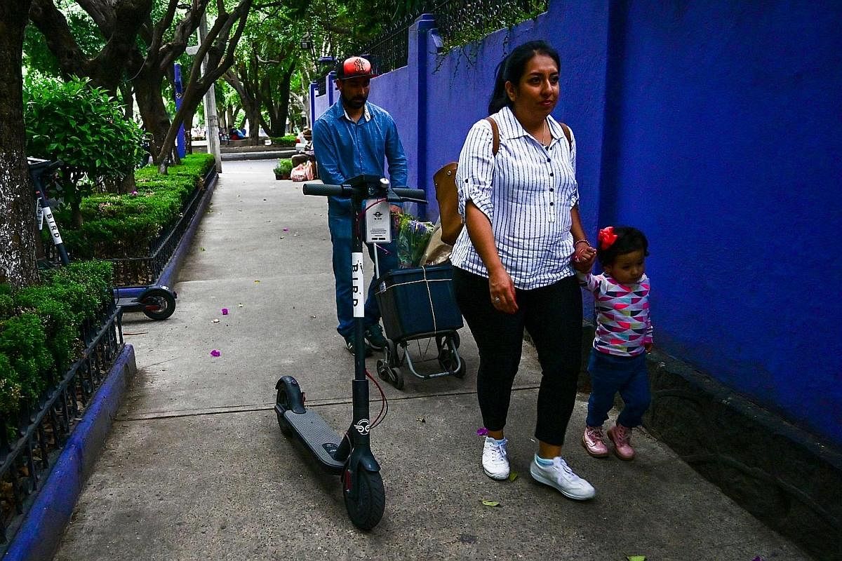 A shared e-scooter left on a neighbourhood sidewalk in Mexico City poses an obstacle to pedestrians. The use of the increasingly popular device is causing safety concerns in cities across Latin America and elsewhere in the world. Critics are urging t