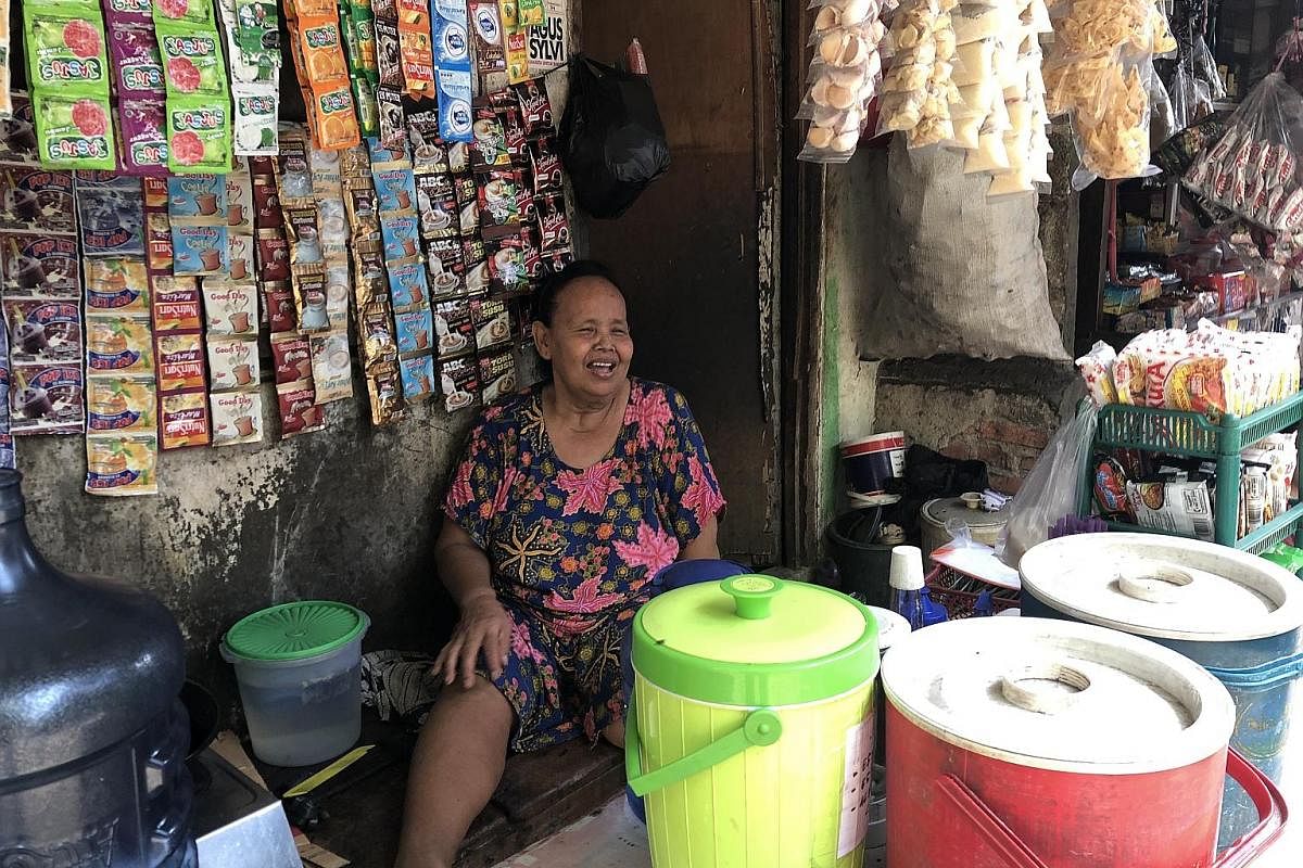 Ms Emo at her store in Muara Baru village, where she has been selling sweets and cigarettes for 40 years. ST PHOTO: JEFFREY HUTTON