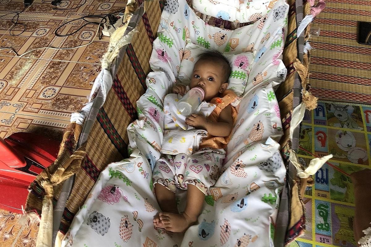 Pump, freeze and send: Ms Parawee Kromnoy sends her breast milk to her five-month-old daughter (above) in Isan, which is 1,200km away from where she lives and works in Phuket, thanks to free air shipping under a new programme.