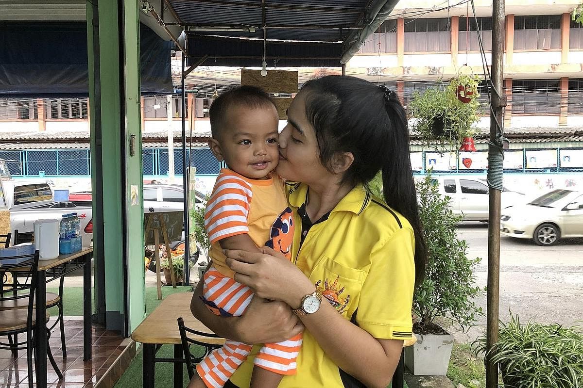 Ms Preeyaporn Eklee, the first participant in the breast milk delivery programme, reuniting with her son, who is 10 months old. Her husband relocated the family to be with her in Khon Kaen in June.