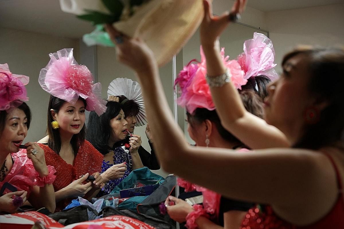 From left: Madam Jasmine Chan, Madam Tan Lee Yong, Madam Annie Phua and Madam Lilian Lim putting on their make-up in the dressing room backstage in preparation for their fashion show.