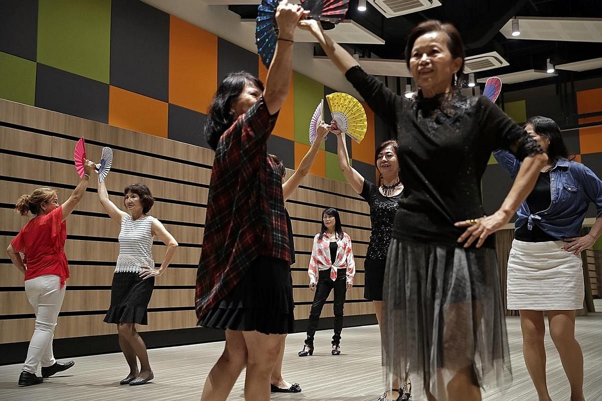 Madam Cheang (centre) watching the women rehearse a dance. The grandmother of one leads the group in simple dance and aerobics movements during their weekly sessions to keep everyone active