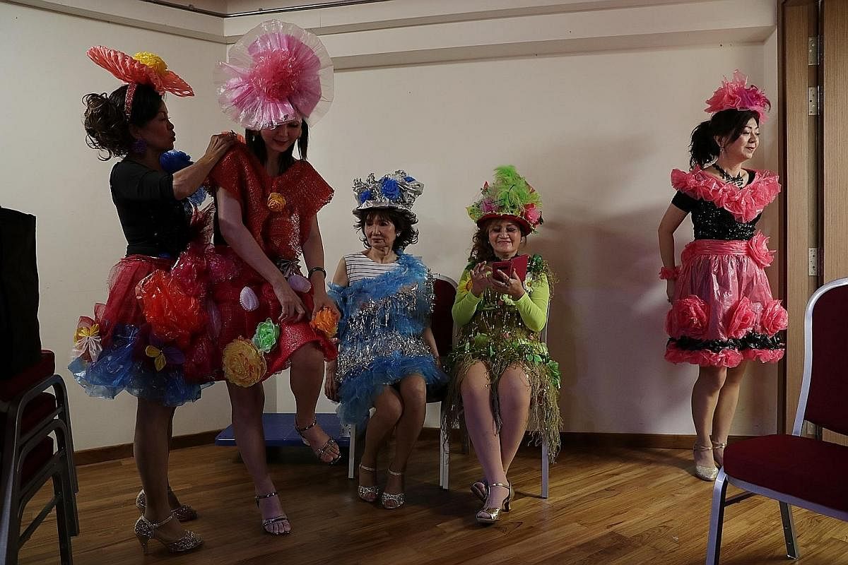 From left: Madam Lily Yap helping Madam Tan Lee Yong secure her outfit as other group members, Madam Lindy Foo, Madam Yong Kim Yin and Madam Jasmine Chan, wait backstage for the start of the fashion show. The group, which meets weekly, has up to 20 member