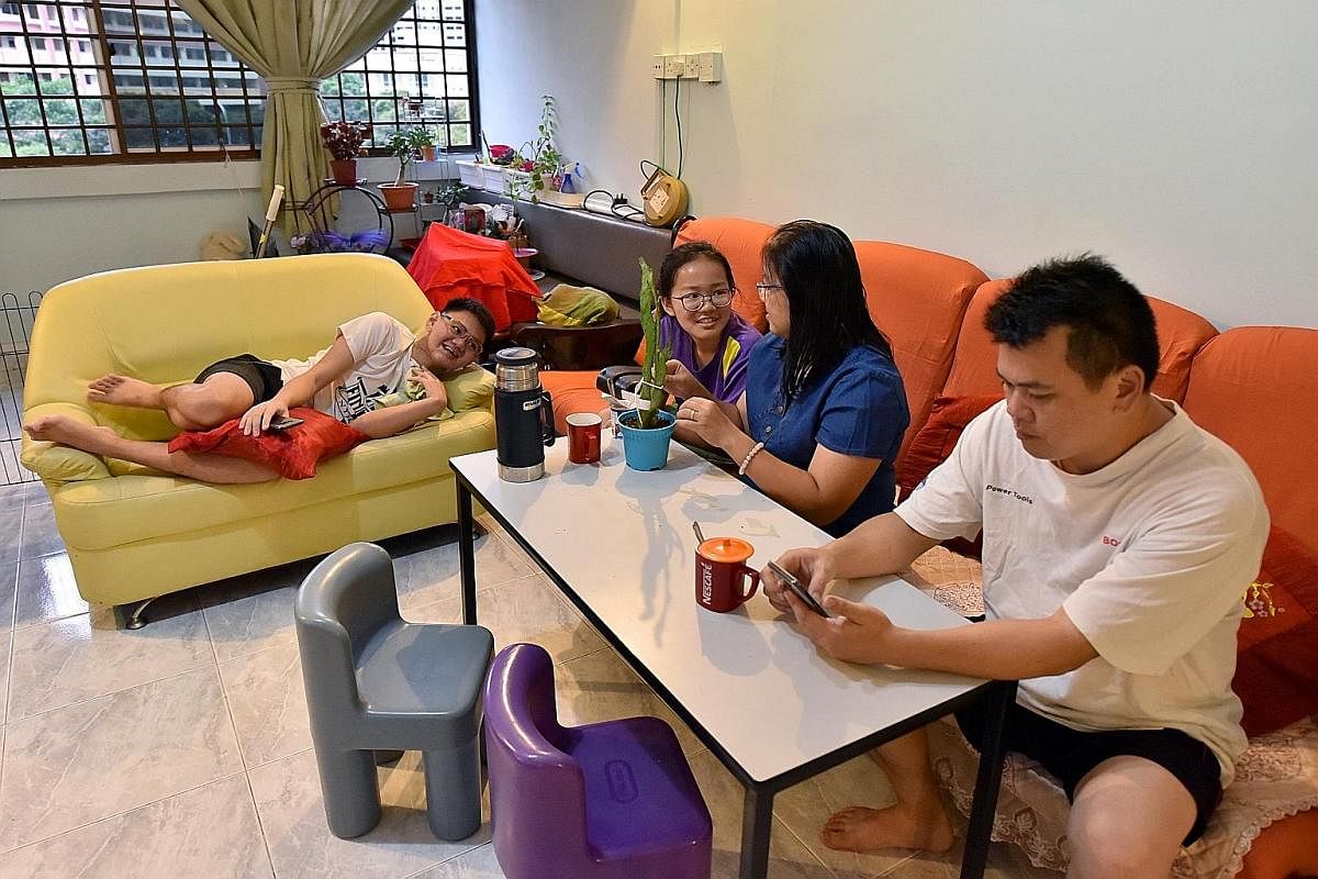 Family time at home: Mr Lim with his parents - Mr Lim Boon Keong and Madam Tan Poh Ling, both 47 - and sister Lim Yong Zhen, 14. Mr Lim performing a piece on his guzheng at Keat Hong Community Club in January. He holds a Grade 9 with distinction in t