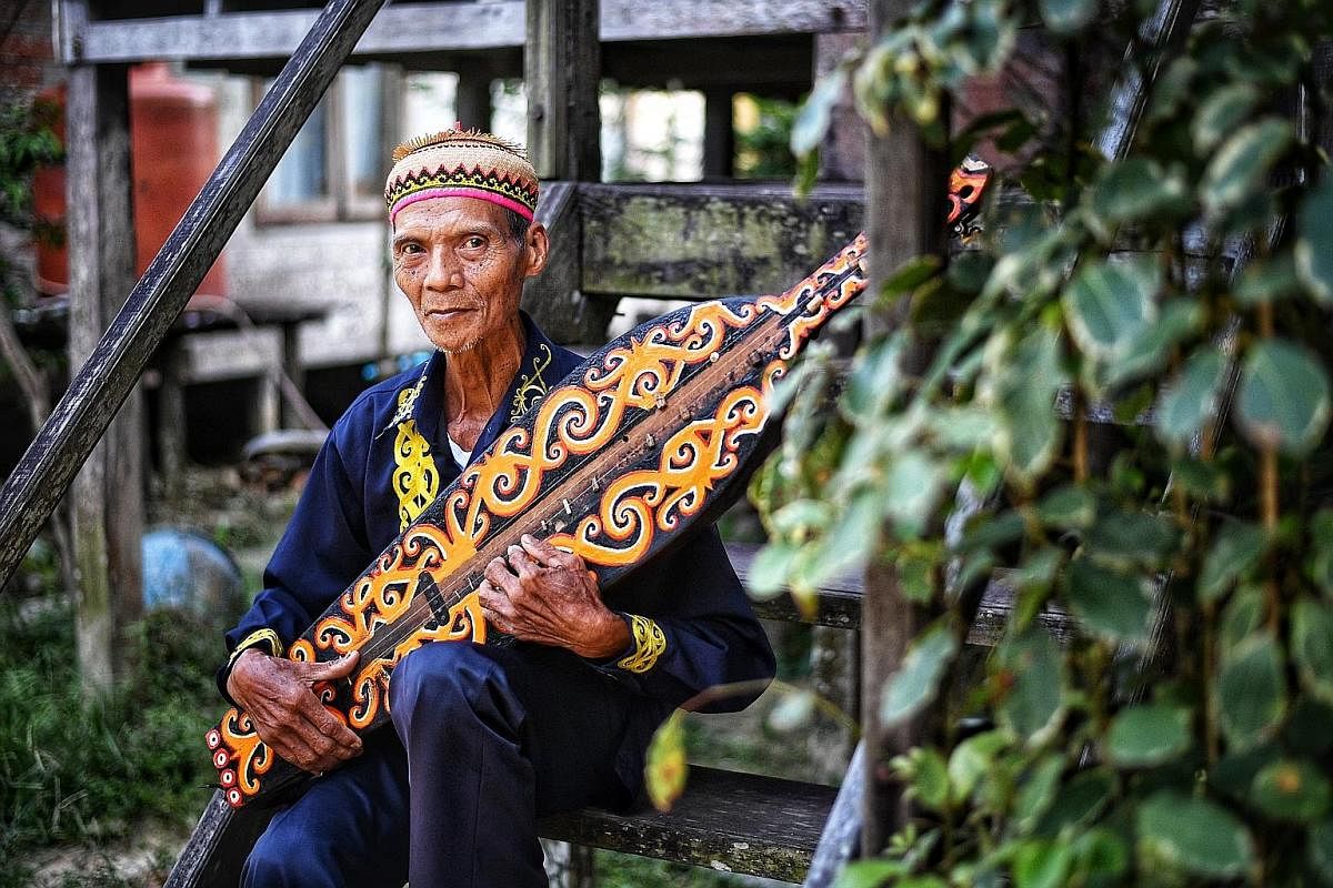 Mr Ujang Laing, 79, who moved to the city with his wife and two children in 1978, still plays the sampe, a traditional lute.