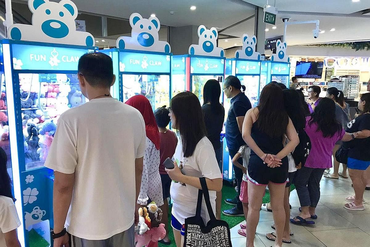 Fun Mall visitors at claw machines by Fun Claw on level one of The Seletar Mall (above).