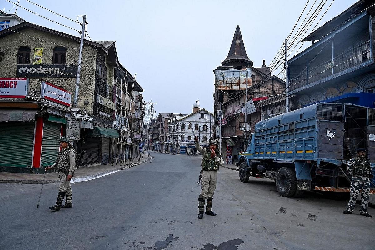 Soldiers standing guard on the streets of Srinagar. New Delhi sent in more than 25,000 troops when it revoked the special status of Jammu and Kashmir in August. Kashmiris busy on their cellphones after the Indian authorities lifted a ban on postpaid 
