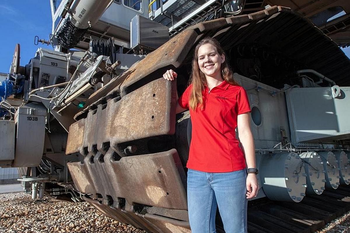 Mechanical engineer Breanne Stichler with Nasa's Crawler-Transporter 2 at the Kennedy Space Centre in Florida in August. She is the youngest and the first female in a while to drive the 3-million-kg machine.