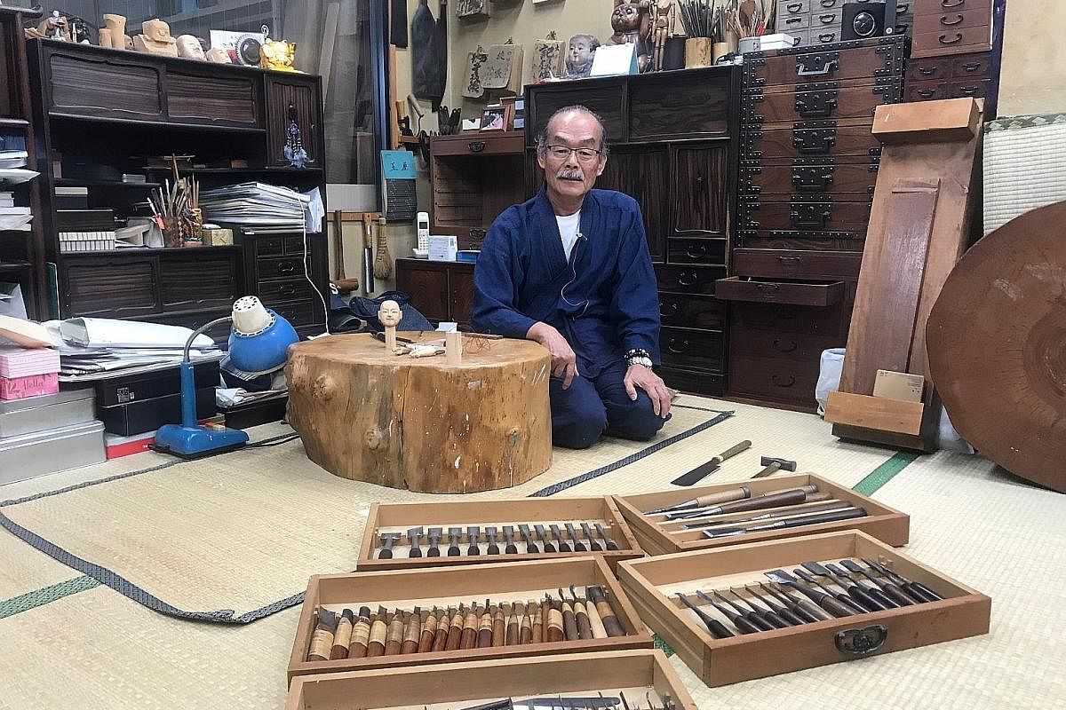 Top: The ninth-generation Tamaya Shobei, 65, with the handcrafted tools he uses to make and repair karakuri dolls. Mr Tamaya, born Shoji Takashina, began his apprenticeship at 25. Above: The skeleton of a karakuri puppet in Mr Tamaya's atelier. The k