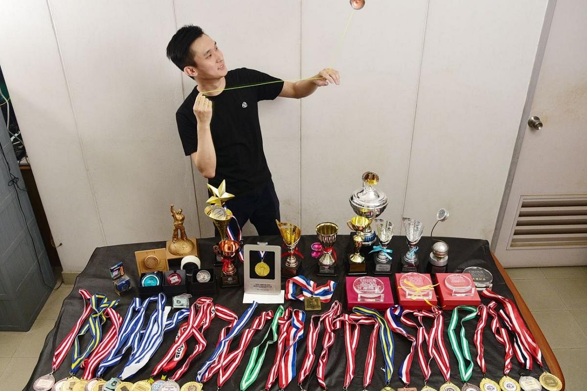 Mr Marcus Koh with his bevy of medals won at national and world yo-yo competitions over the years.