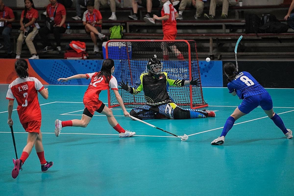 Singapore goalkeeper Fariza Begum Zabir blocking a shot by Thailand's Nelly Johansson in the SEA Games women's floorball final in Manila. Jerelee Ong netted the winner in the 3-2 victory. 