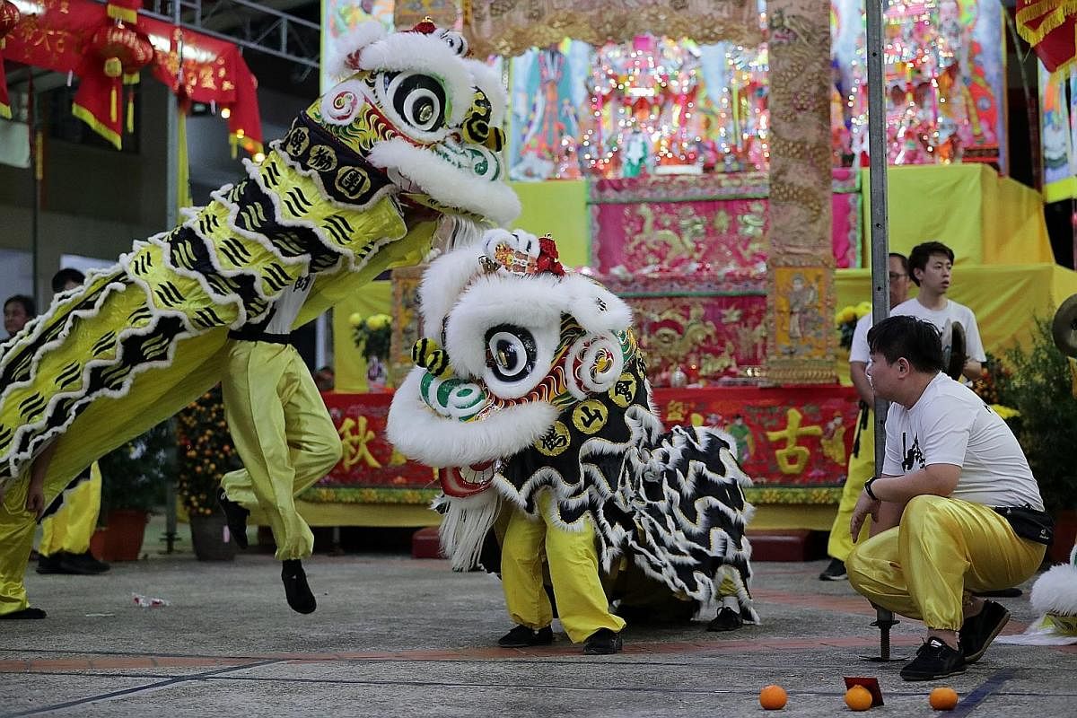 Troupe leader Lui Kai Keong coaching young members (from left) Rovin Ng, Ronald Ng and Seah Kia Wee in basic martial arts moves. As lion dance is closely linked with martial arts, practitioners must master basic martial arts skills to become good lio
