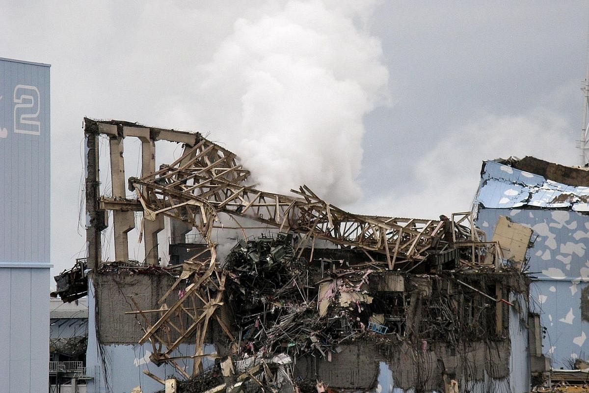 White smoke seen rising from a reactor building, in a picture taken between March 15 and April 11, 2011, at the Tepco Fukushima Daiichi nuclear plant after the tsunami caused a nuclear accident. Bags of rice being inspected for radiation levels in Fu
