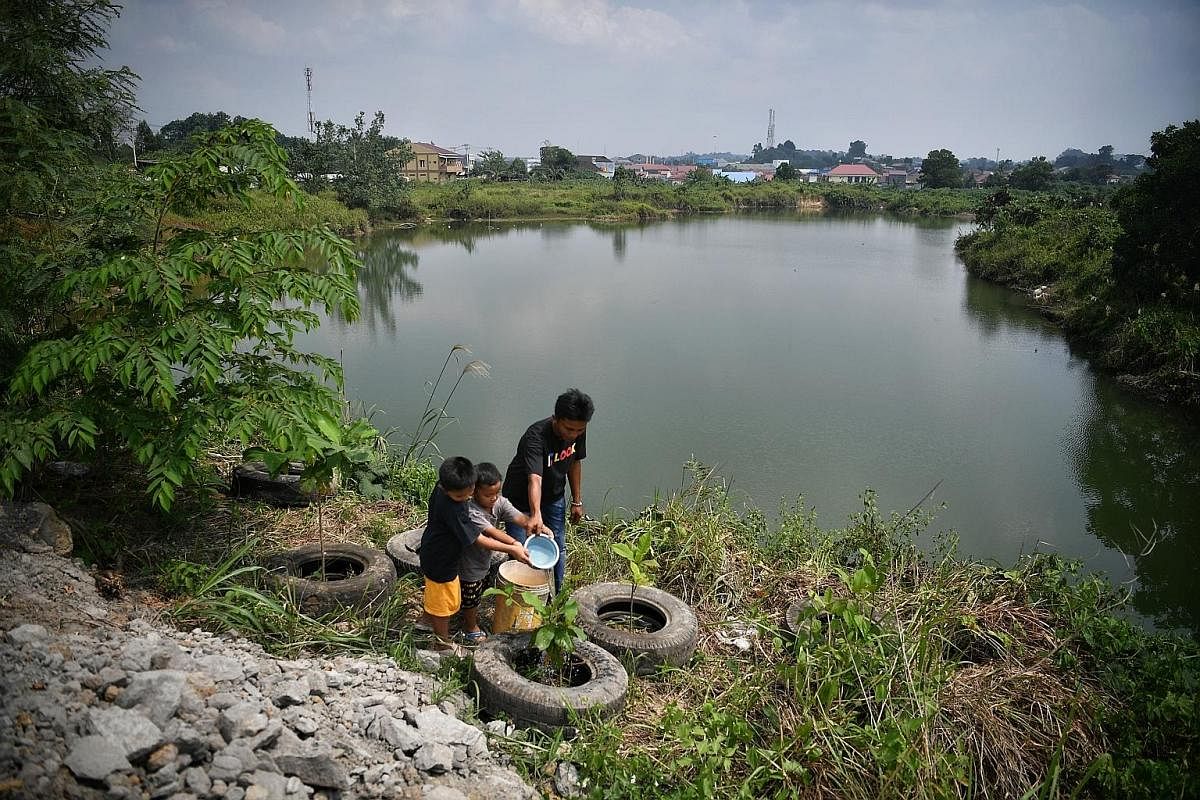 Right: A location believed to be an illegal mining pit in Samarinda, the provincial capital of East Kalimantan. Left: Fish breeder Marsulap returning from his fish farm in a mine lake that is now a source of income for his family. Far left: Miner Sug