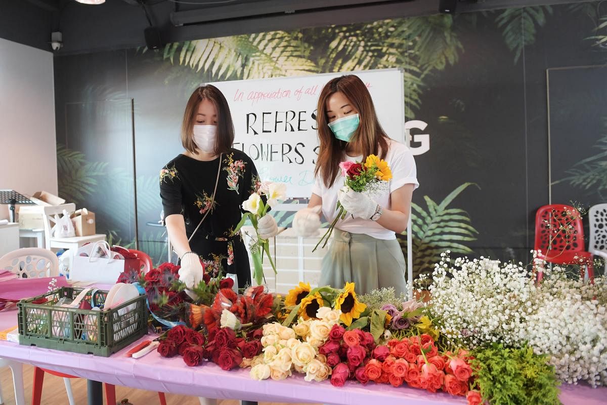 Ms Livia Chng (left) and Ms Sharon Phua from Refresh Flowers SG repurposed flowers from donated Valentine’s Day bouquets for front-line and healthcare staff. 