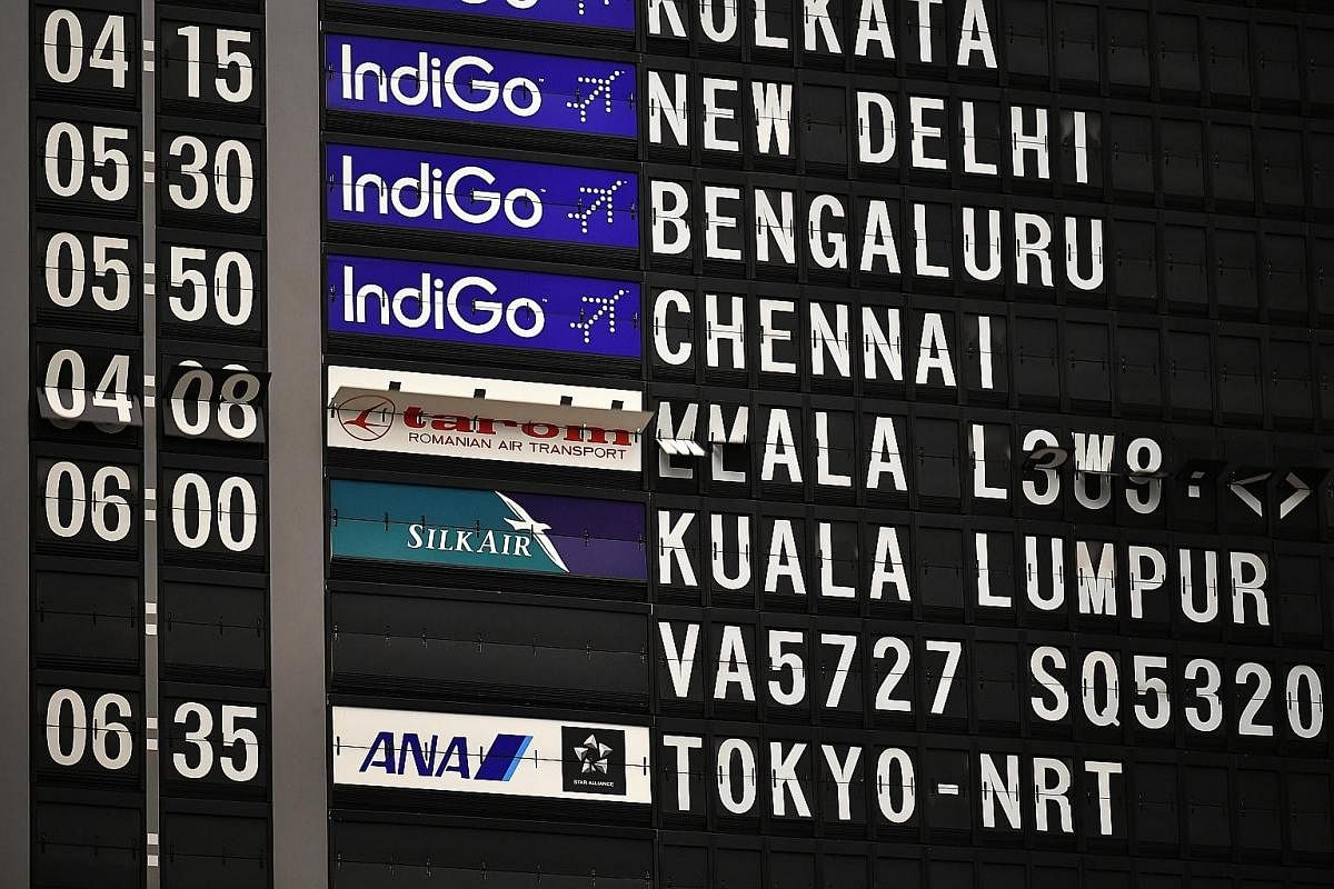 Above: The analogue flip board flipping to reflect flight information before it was decommissioned at about 11.30pm on Feb 6. The board has about 1,600 single-character capsules, about 240 double-character capsules to indicate time, and 240 capsules 